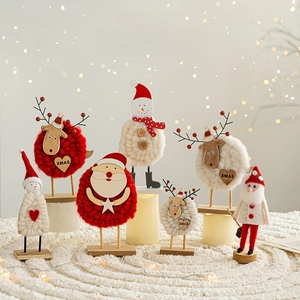 Charming wool felt Christmas snowman and reindeer decor on a warm wooden base