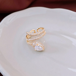 Detail of gold snake ring with white zircon pavé and pear-shaped center gemstone