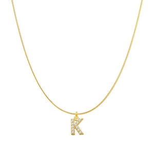 Close-up of golden necklace with crystal-studded letter K pendant on a round snake chain