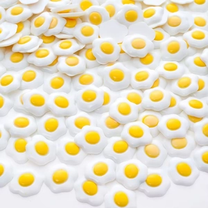 Macro shot of miniature resin fried eggs charms for DIY phone case crafts and accessories