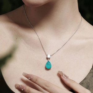 Detailed view of 925 silver necklace with teardrop Paraiba tourmaline stone pendant