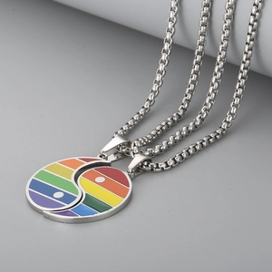 Macro detail of rainbow enamel Yin Yang couple pendants on stainless steel box chain