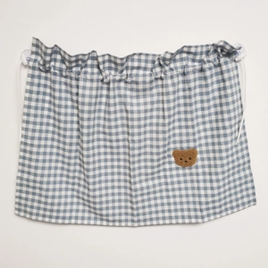 Detail of blue checkered car sunshade curtain with brown bear embroidery and suction cups