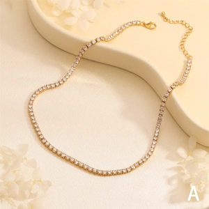 Close-up of a gold-plated tennis necklace with sparkling round-cut zircon stones