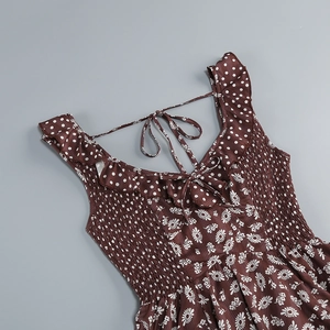 Detail of floral daisy print fabric with ruffled neckline and smocked chest texture