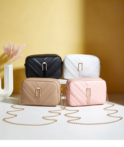 Close-up of V-quilted faux leather bags in four colors with gold metal chain straps