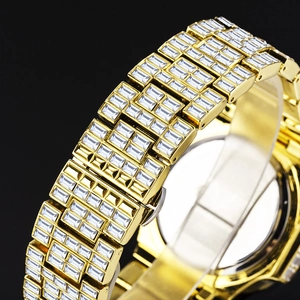 Detailed macro view of the gold-plated link strap with handset rectangular crystals
