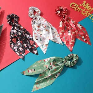Set of four Christmas silk scrunchies with ribbons featuring Santa and elk festive patterns