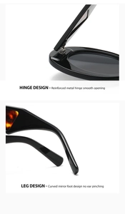 Close-up of reinforced metal hinges and curved temples on black oval sunglasses