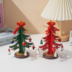 DIY mini wooden Christmas tree decorations in red and green with festive hanging ornaments