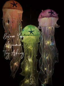 Three colorful glowing jellyfish hanging lamps with mesh texture on black background