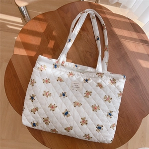 Detail of quilted cotton tote bag with vintage bear prints and French fabric patch