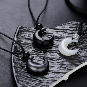 Polished crescent moon pendant necklaces in black, white and grey with woven cords