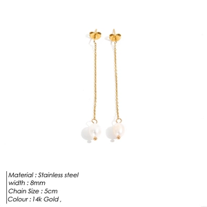 Macro detail of 14k gold plated stainless steel long chain earrings with pearl pendants