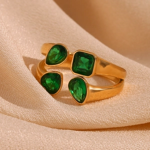 Close-up of gold double-layer open ring with green pear-cut and square-cut zircon stones