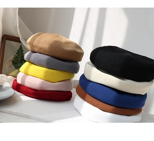 Detail shot showing various colors of breathable knitted beret hats for women