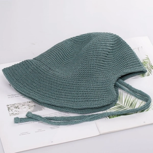 Close-up of handmade crochet bucket hat in forest green with detailed knit texture