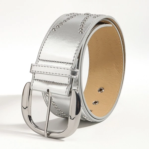 Detail view of silver studded vintage leather belt with classic horseshoe metal buckle