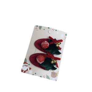 Pair of festive Christmas reindeer bell hair clips with red velvet and green tree decor