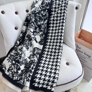 Detail of cashmere-like scarf showing houndstooth pattern and artistic tree design with fringe