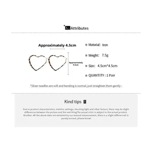 Detail view of leopard print heart earrings with dimensions 4.5cm and iron material