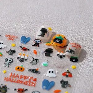 Macro detail of 3D Halloween nail stickers with pumpkins and ghosts on a manicure