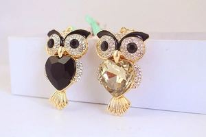 Detailed view of owl keychains with sparkling rhinestones and heart-shaped crystals