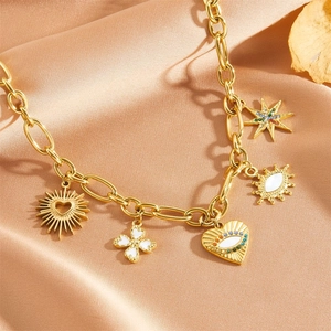 Golden Evil Eye necklace set with sun, clover, and heart charms on silk background