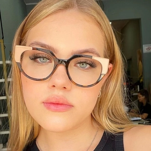 Close-up of stylish cat-eye TR90 frames in tortoiseshell and beige worn by a model