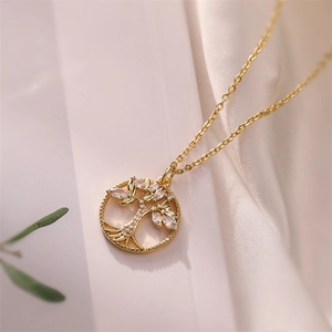Macro shot of gold Tree of Life pendant with white marquise zircons on an O-chain link