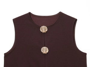 Detailed view of dark brown sleeveless vest featuring gold shell-shaped decorative buttons