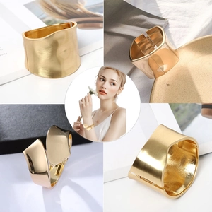 Minimalist gold wide open cuff bracelet with irregular wave design and brushed metal finish