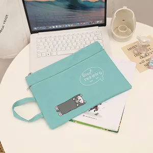 Detail of green husky canvas document bag with handle and 'Good morning' print