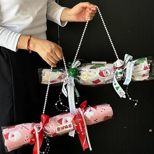Christmas gift bags with Santa and tree motifs, pearl handles, and festive ribbon bows