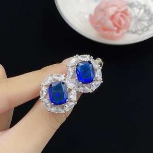 Elegant halo earring with London blue rectangle stone and marquise zircon accents
