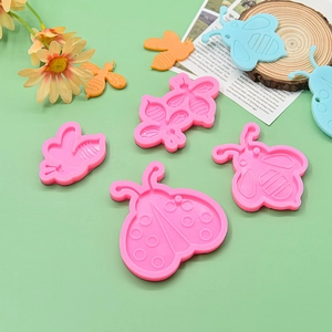 Pink silicone insect molds for DIY honeybee, ladybug, and butterfly epoxy resin earrings