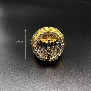 Macro detail of gold-plated hip-hop ring featuring 23mm Jesus cross and white zircons