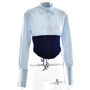 Detail showing the mixed blue and white striped shirt collar and navy blue corset waist