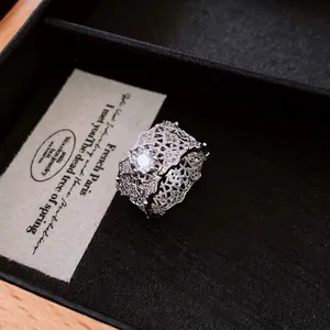 Lace style hollow silver ring with zircon stones in a vintage French jewelry box