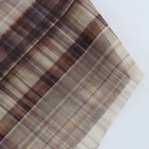 Close-up of semi-transparent brown plaid mesh fabric texture with classic checkered pattern