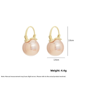 Detailed view of gold pearl earrings with dimensions 2.6cm by 1.4cm and 4.4g weight