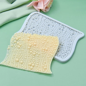 Light blue silicone bubble pearl texture mold with yellow sample on green surface