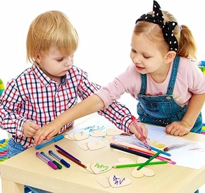 Children drawing on heart-shaped DIY blank wooden slices with colorful markers