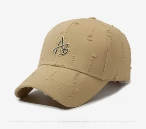 Detail of khaki baseball cap with 'B' embroidery and vintage distressed ripped finish