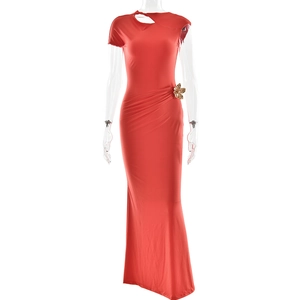 Close-up of red slim fit maxi dress featuring side cutout and golden bow detail