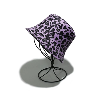 Close-up of a purple leopard print bucket hat with dense stitching on a metal stand