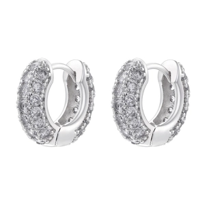 Detailed macro view of wide hoop earrings with paved white zircons in silver finish