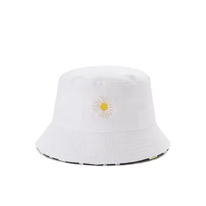 Close-up of daisy embroidery with missing petal on a white cotton bucket hat