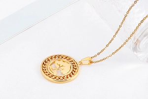 Detailed macro shot of a golden Tree of Life hollow circular pendant on a sleek metal chain