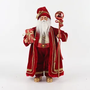 Detail of 50cm Santa Claus figurine in red velvet robe holding gift box and staff